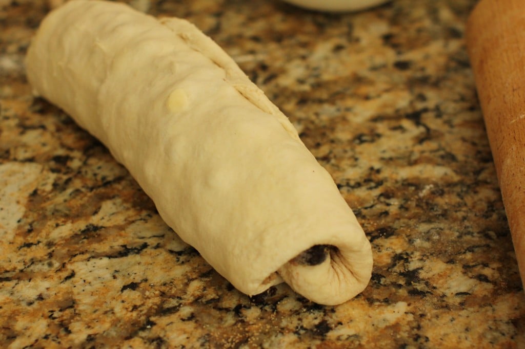 dough all rolled up and ready to be cut for the saskatoon rolls