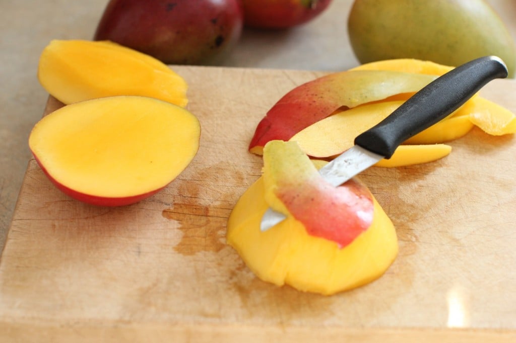 how to cut a mango - peel the cheeks