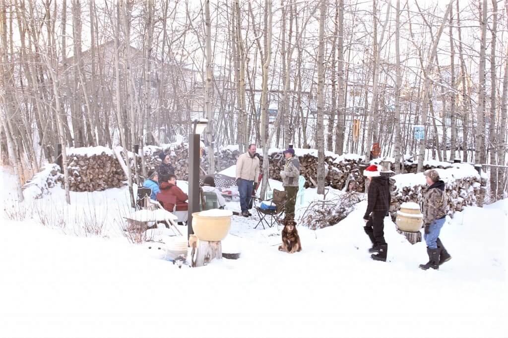 drinking mulled wine around the campfire in winter