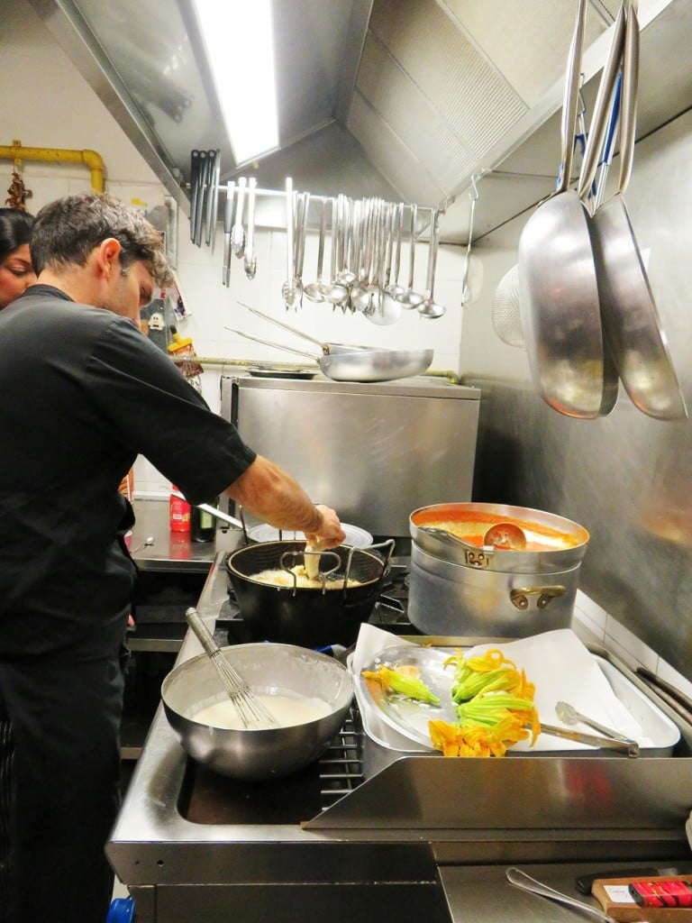 chicken breasts in orange sauce, chef Andrea frying the zucchini blossoms