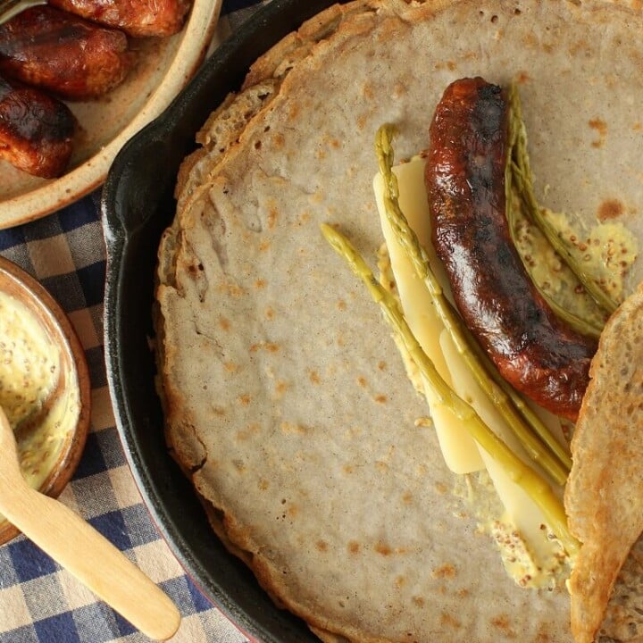 buckwheat galettes taste mighty good with a smear of Dijon mustard, a grilled sausage, cheese, and pickled asparagus,