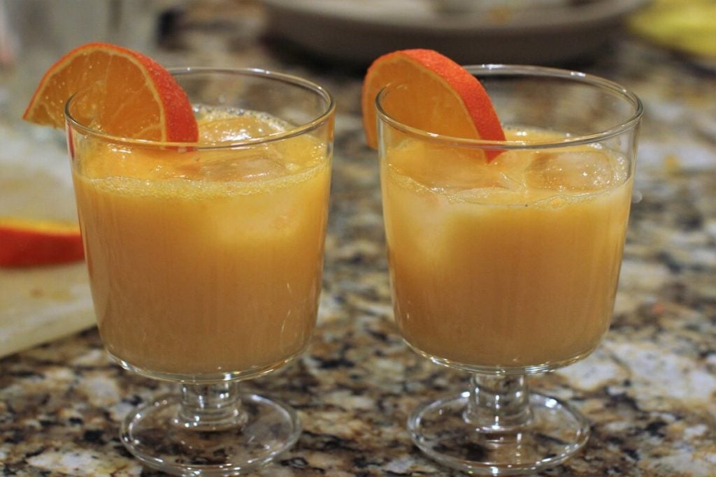 orange cream sodas in two glasses with orange slices on the rim