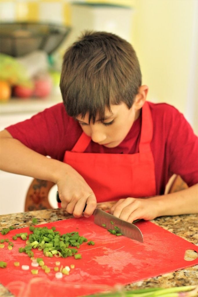 chopping green onions for the chicken pasta salad