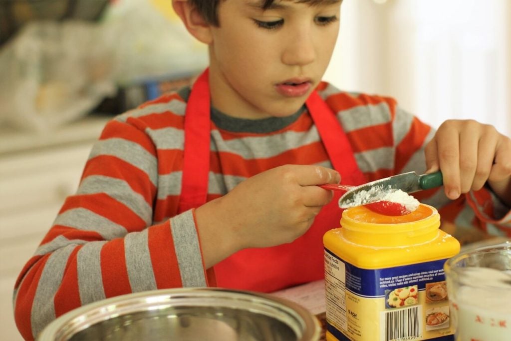 Eric measures cornstarch for the homemade vanilla pudding