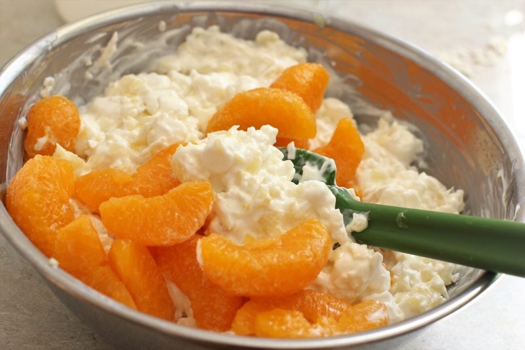 stirring together the ambrosia salad