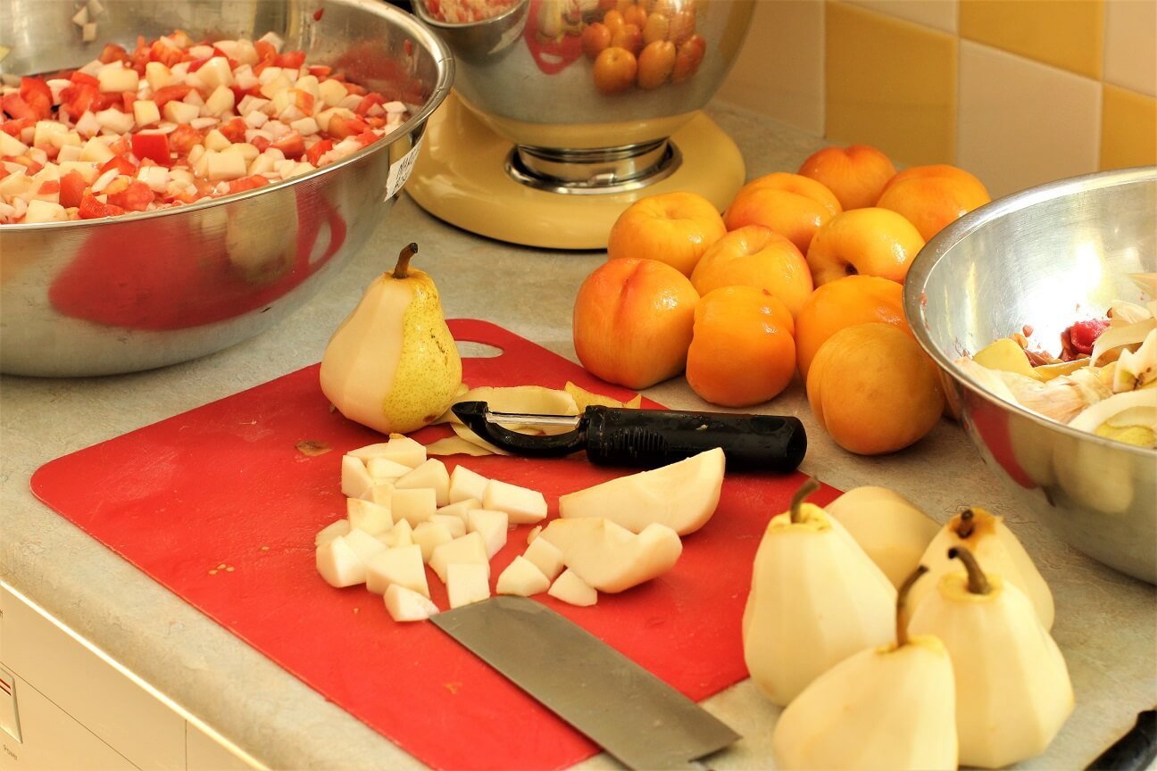 dicing the fruit, diced pears on a red cutting board