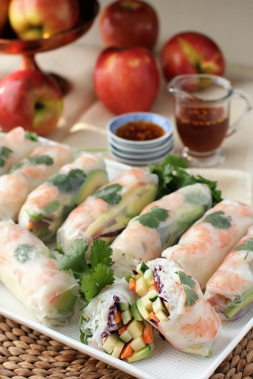 apples in background, summer rolls in front