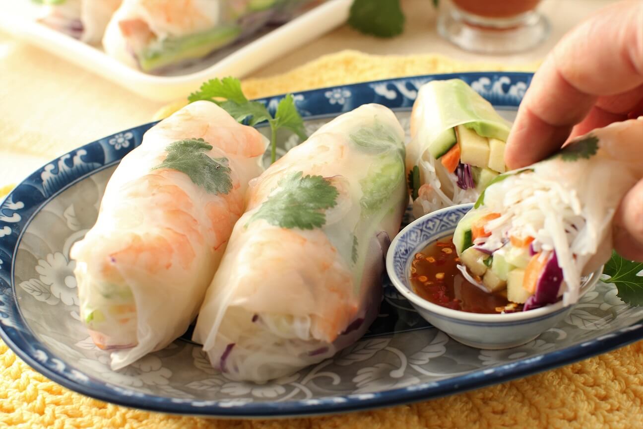 dipping the roll into the sauce