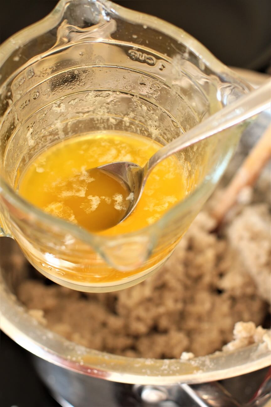dipping the spoon into the melted butter