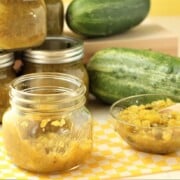 horizontal view of relish jars and overripe cucumbers