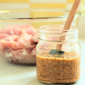 jar of souvlaki marinade and bowl of meat