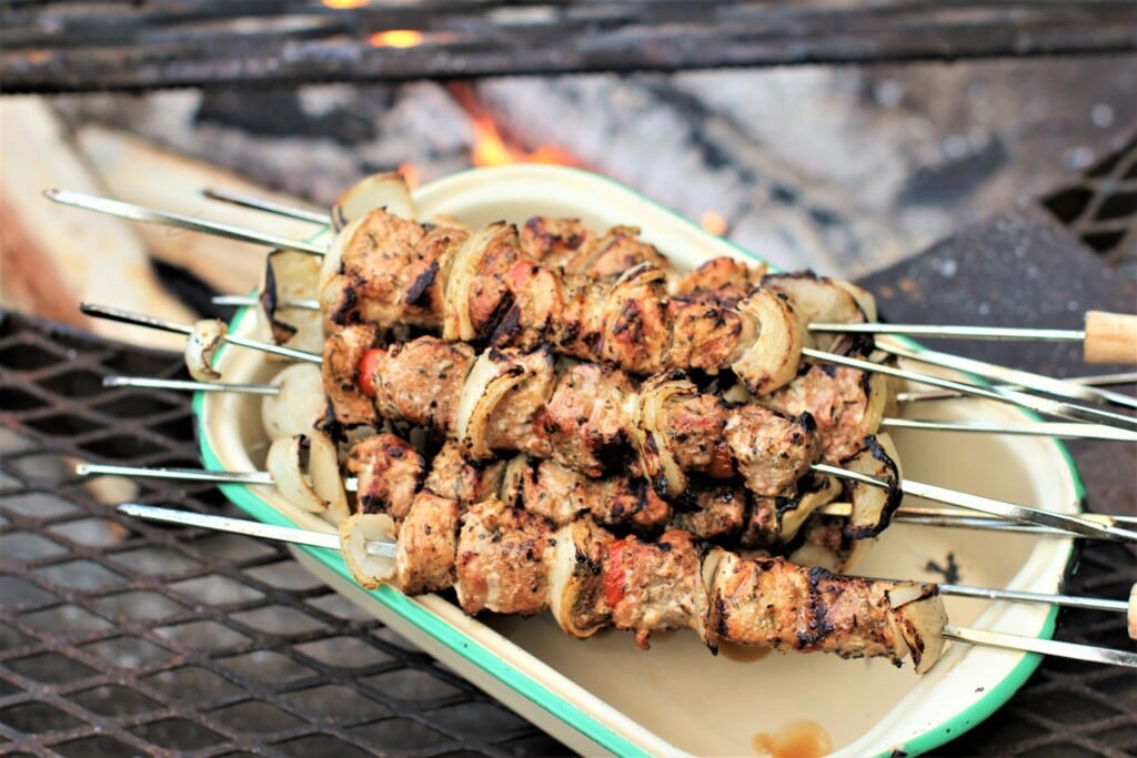 pile of shish kabob skewers in metal dish
