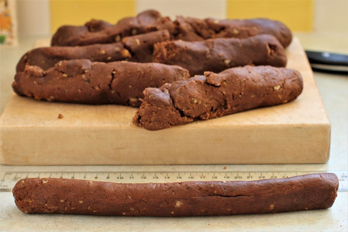 a rolled strip of dough in front of the cutting board.