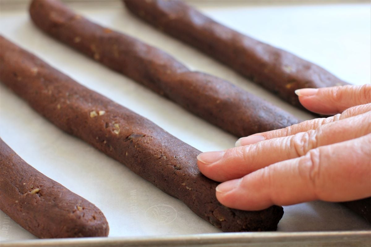 pressing down the strips of dough with fingertips.