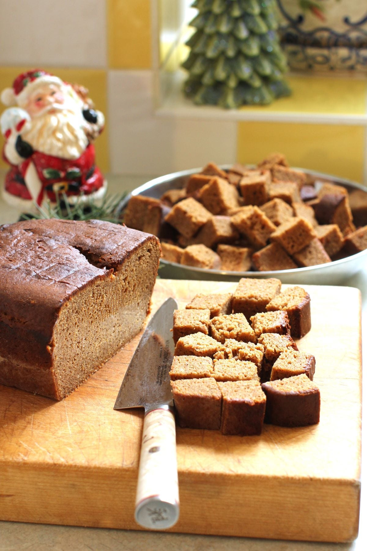 cutting cubes of Lebkuchen loaf on the cutting board.