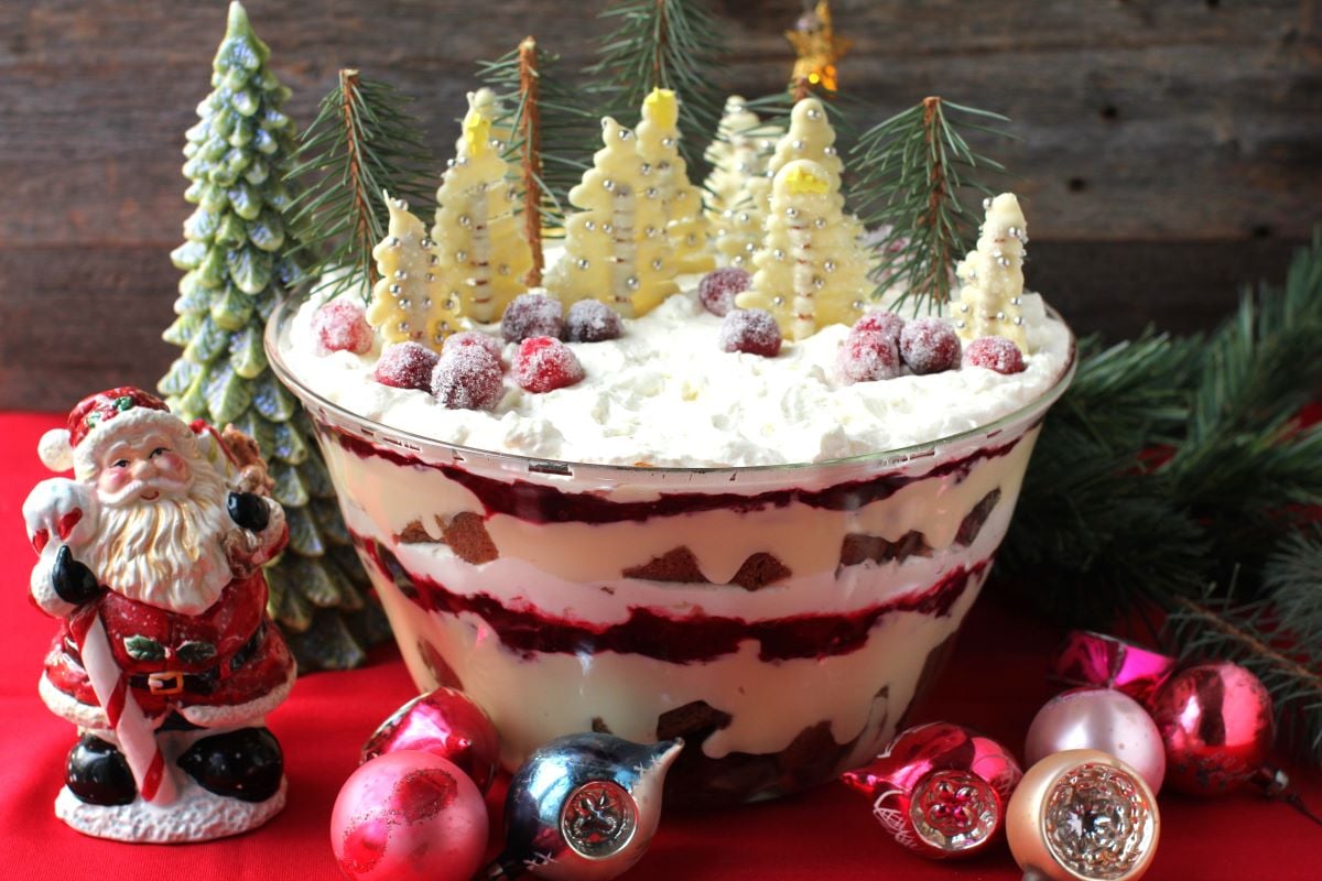 the big trifle bowl filled with layers of Lebkuchen Christmas trifle and topped with little white chocolate trees.