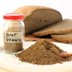 thumbnail photo of mound of German bread spice, jar of Brot Gewürz, loaf of rustic bread.