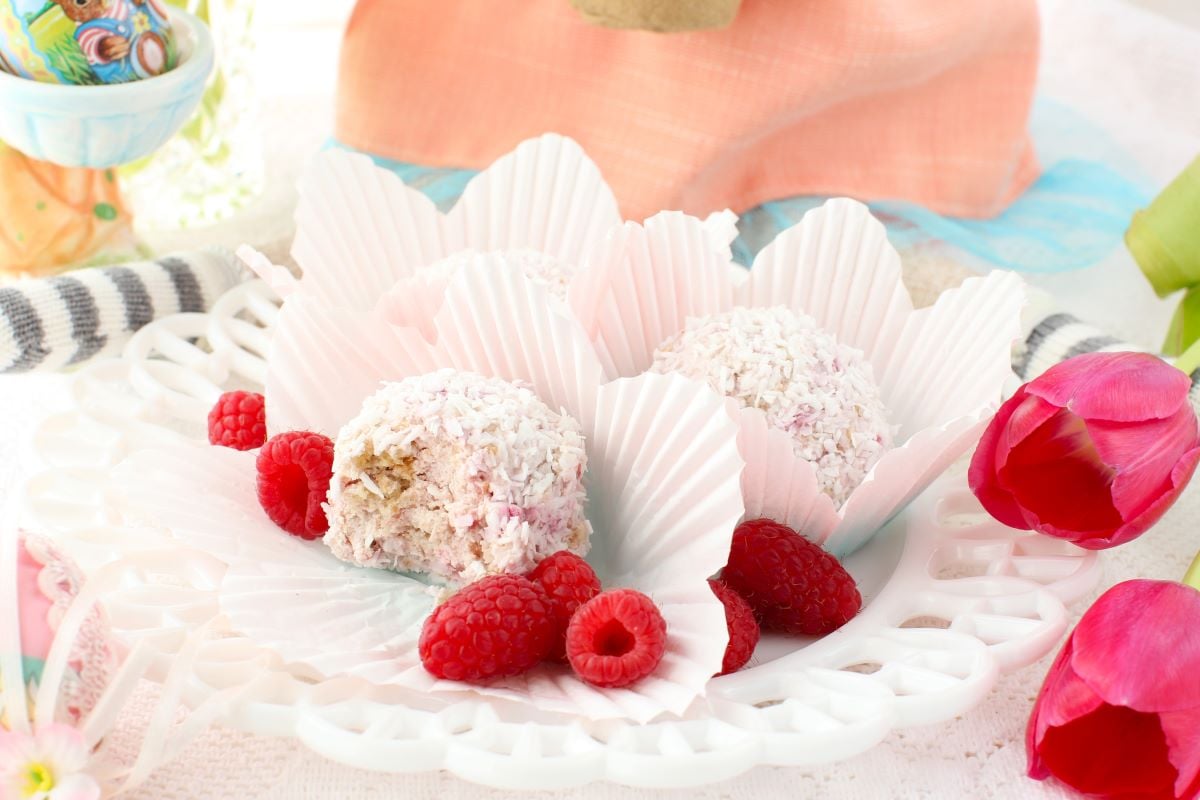 Raspberry Schneeballen on a white plate with fresh raspberries.