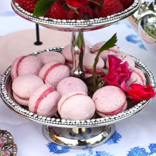Square thumbnail of Raspberry Meringue Kisses on a silver tiered tray, with pink flowers.