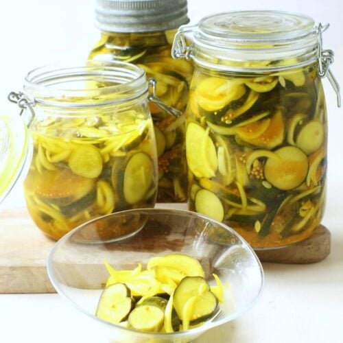 Square thumbnail of 3 jars of bread & butter pickles, with a small bowlful in front.