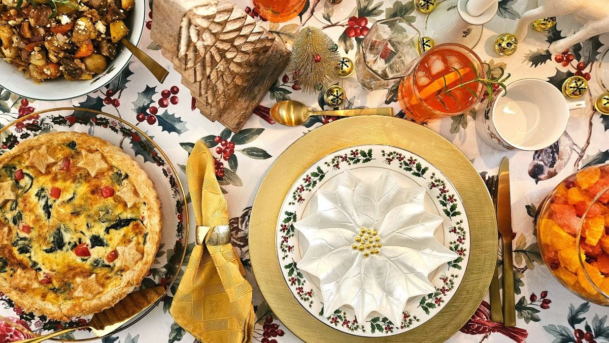 The Christmas quiche and a holiday table setting in gold and white.
