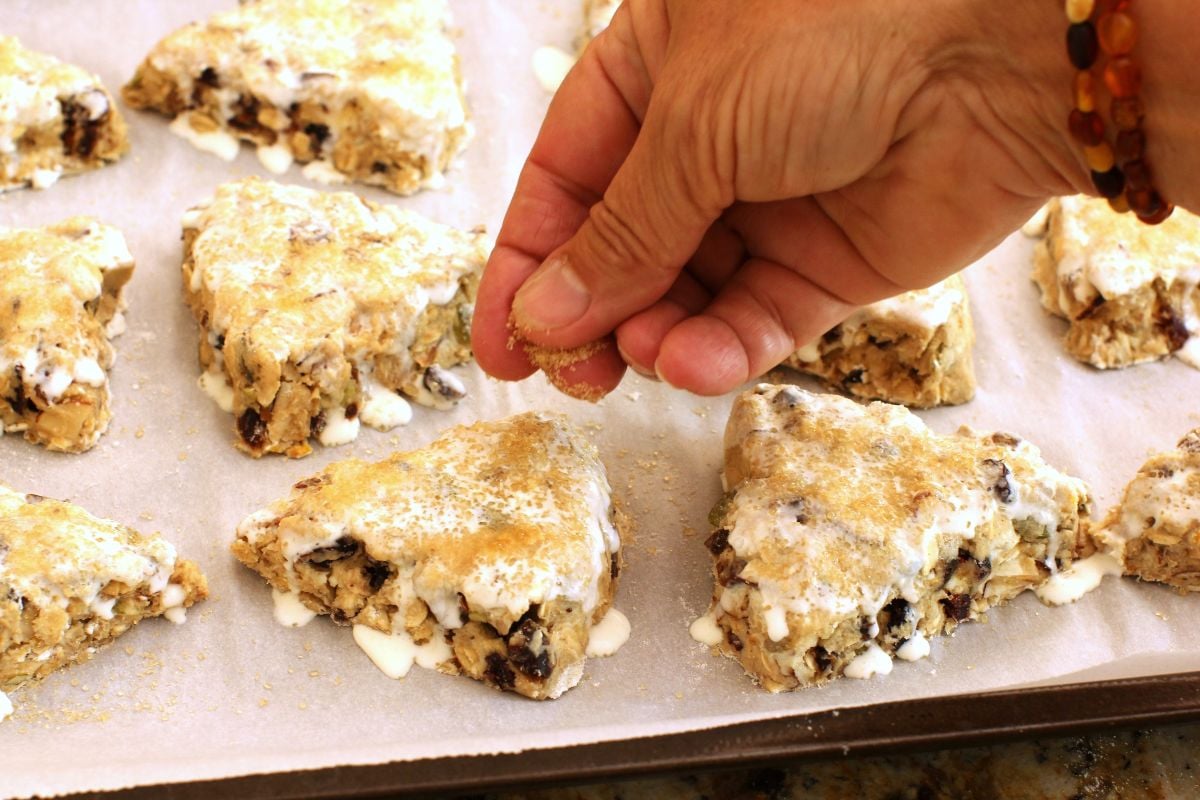 Sprinkling the top of the scones with sugar.