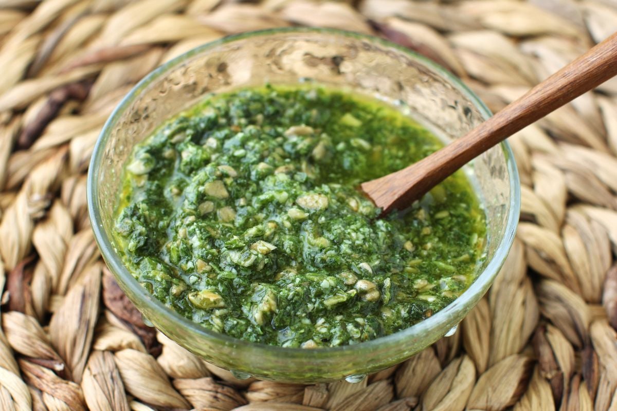 Small bowl of sorrel pesto on a seagrass mat.